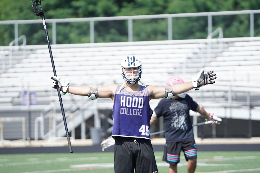 Lacrosse player gripping shaft